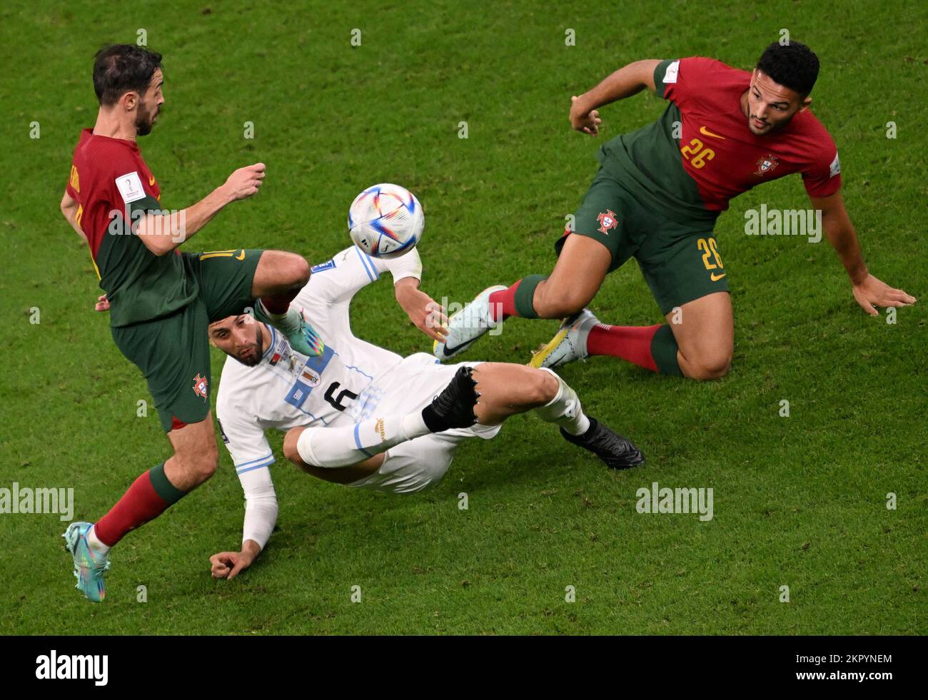 Lusail, Qatar. 28th Nov, 2022. Bernardo Silva (L) of Portugal, Rodrigo Bentancur (C) of Uruguay and Goncalo Ramos of Portugal compete during the Group H match between Portugal and Uruguay at the 2022 FIFA World Cup at Lusail Stadium in Lusail, Qatar, Nov. 28, 2022. Credit: Xia Yifang/Xinhua/Alamy Live News Stock Photo