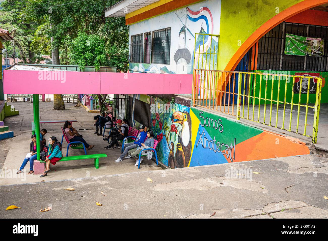 Teens and young adults seated in a sheltered space in the community center in the municipal park in Jinotega, Nicaragua. Stock Photo