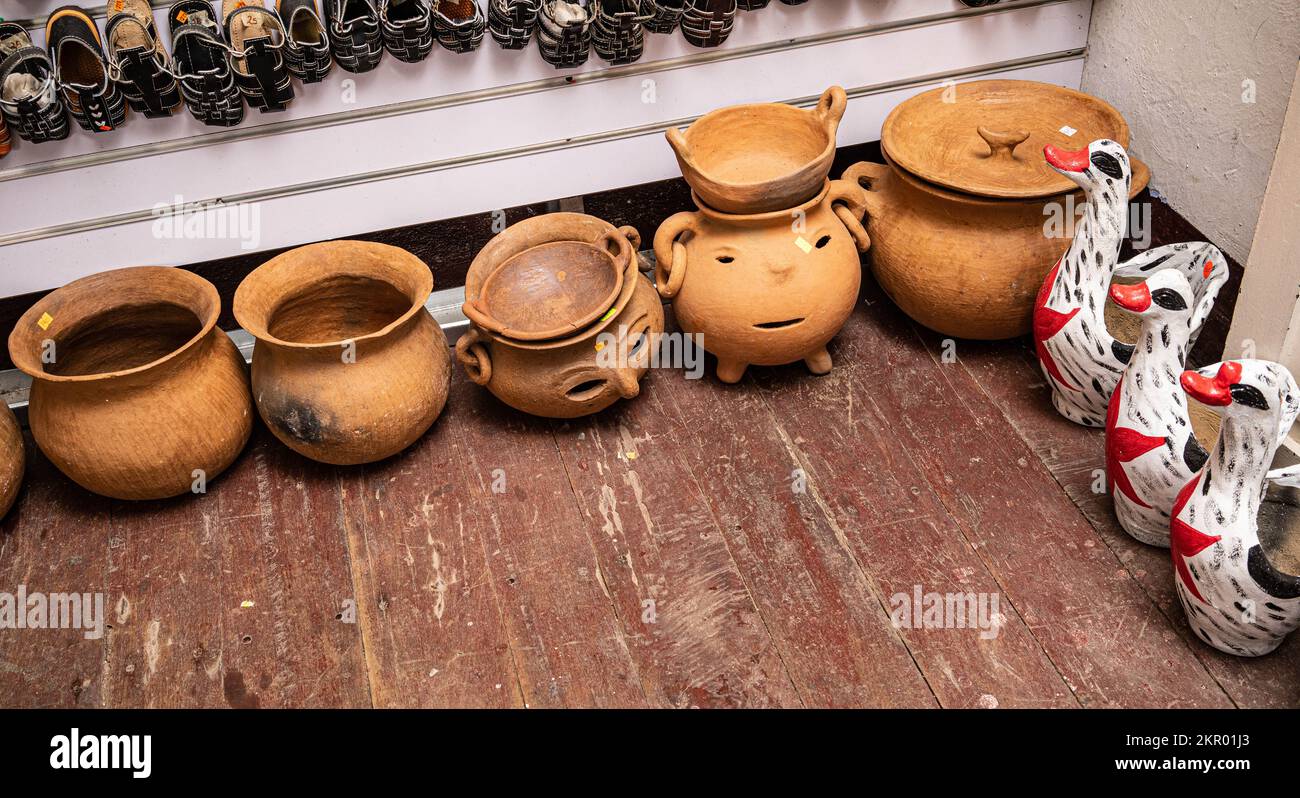 Nicaraguan handcrafts: sandals, earthenware pots and glazed ceramic hens in a handcraft store in Nicaragua. Stock Photo