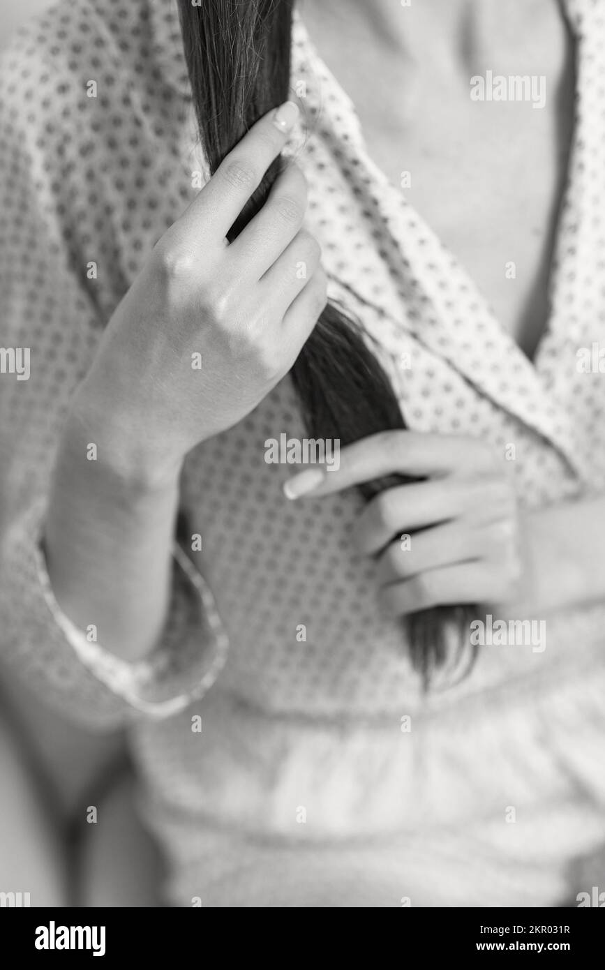 female hands hold long smooth hair. closeup Stock Photo