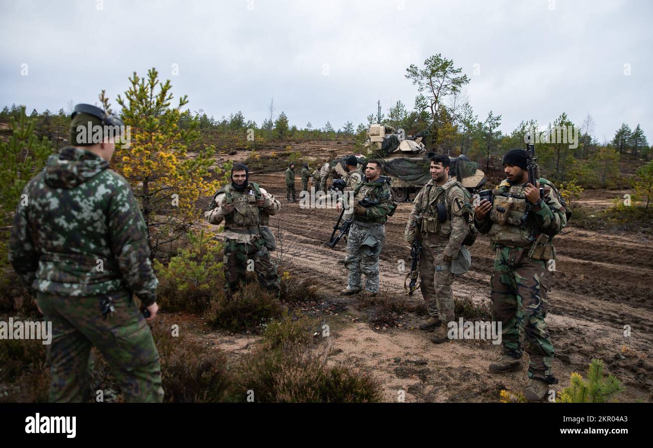 U.S. Soldiers with 6th Squadron, 9th Cavalry Regiment, 3rd Armored Brigade Combat Team, 1st Cavalry Division (3-1 ABCT), operationally assigned to the 1st Infantry Division (1 ID), conduct an after action review with a Finland’s Army Headquarters, Armored Brigade, Pori Brigade, Karelia Brigade, Uti Jaeger Regiment and Logistics Department of the Defense Forces, in Niinisalo, Finland, Nov. 4, 2022. The 3-1 ABCT is among other units under the 1 ID proudly working alongside allies and regional security partners to provide combat-credible forces to V Corps, America’s forward deployed corps in Euro Stock Photo