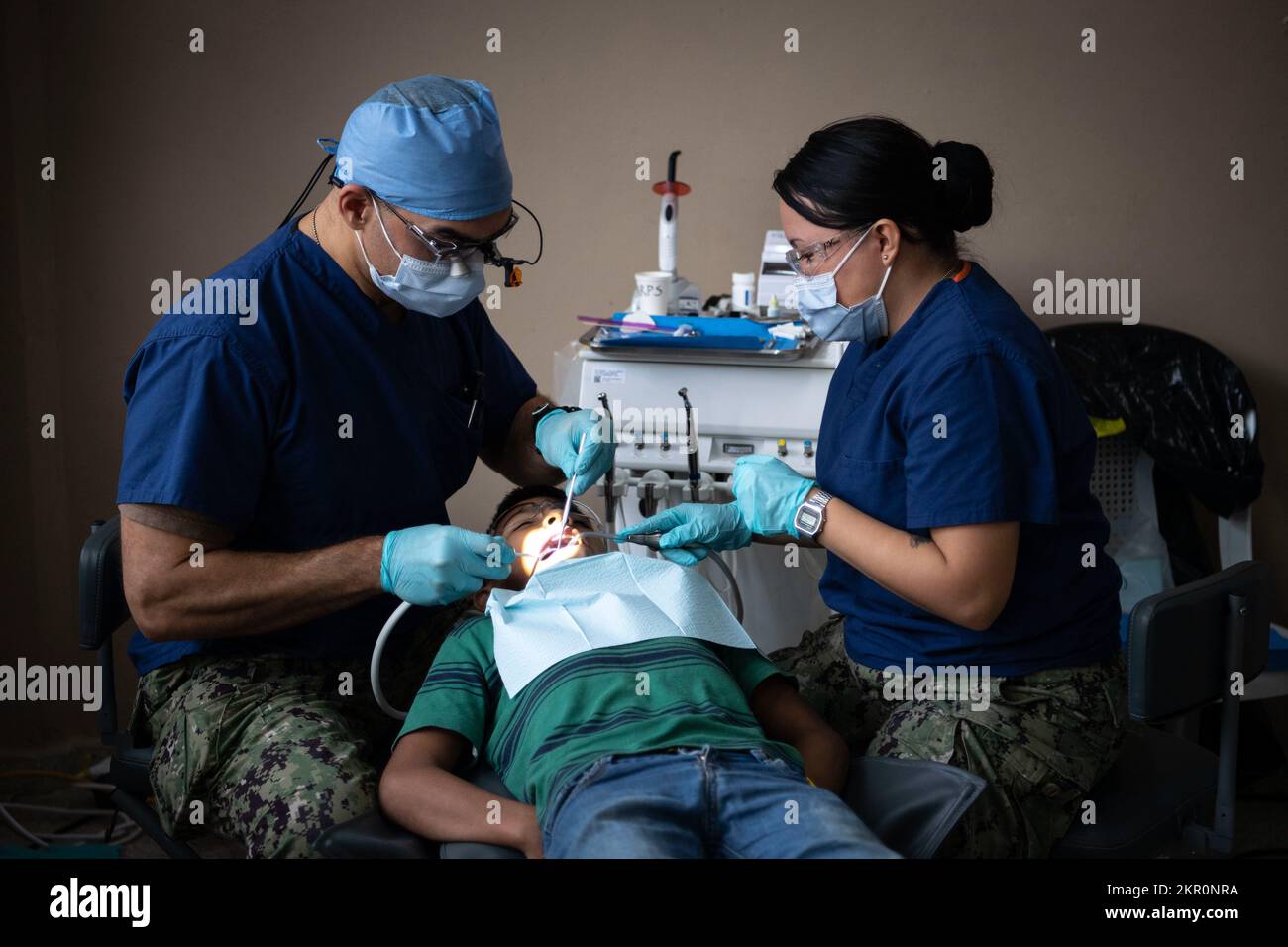 221105-N-TR141-1055 PUERTO CORTES, Honduras (Nov. 5, 2022) Lt. Cmdr. Jonathan Blaze Negron, a dentist from Port St. Lucie, Florida, and Hospital Corpsman Britny Cruz-Rivera, a dental technician from Clearwater Florida, both attached to the hospital ship USNS Comfort (T-AH 20) for Continuing Promise 2022, conduct dental procedures for Hondurans at a medical site in Puerto Cortes, Honduras, Nov. 5, 2022. Comfort is deployed to U.S. 4th Fleet in support of CP22, a humanitarian assistance and goodwill mission conducting direct medical care, expeditionary veterinary care, and subject matter expert Stock Photo