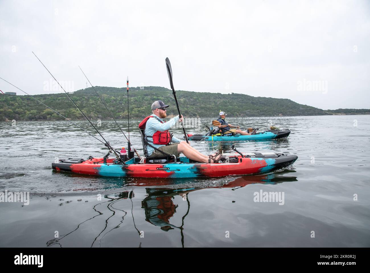 Two men bass fishing from kayaks on Possum Kingdom Lake Texas Stock