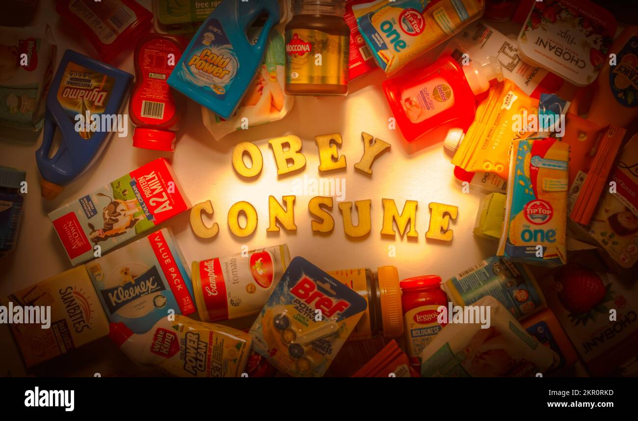 A subliminal exposé in hidden commands from commercials and television programming.  Obey. Consume. Stock Photo
