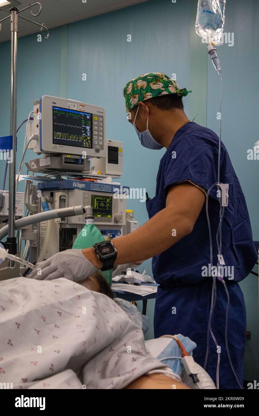 PUERTO CORTES, Honduras (Nov. 05, 2022) Lt. Cmdr. Joseph Dimarucut, assigned to the hospital ship USNS Comfort (T-AH 20), verifys the vitals of the patient, at the ship during Continuing Promise 2022, Nov. 05, 2022. CP22 is a humanitarian assistance and goodwill mission conducting direct medical care, expeditionary veterinary care, and subject matter expert exchanges with five partner nations in the Caribbean, Central and South America. Stock Photo