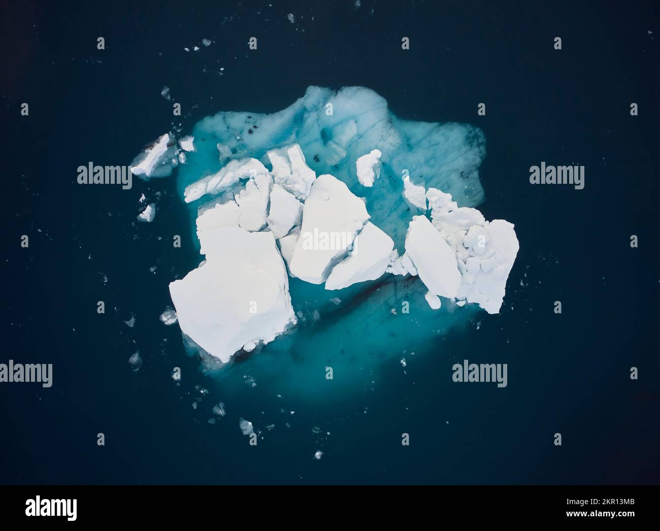 Iceberg in green calm seawater Stock Photo