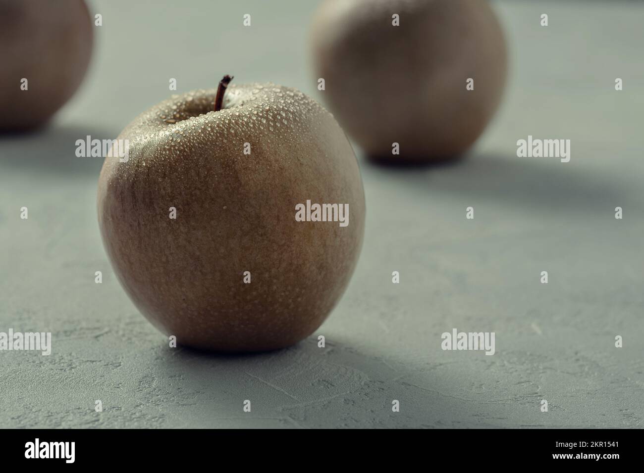 Yellow orange apples on a grey table Stock Photo