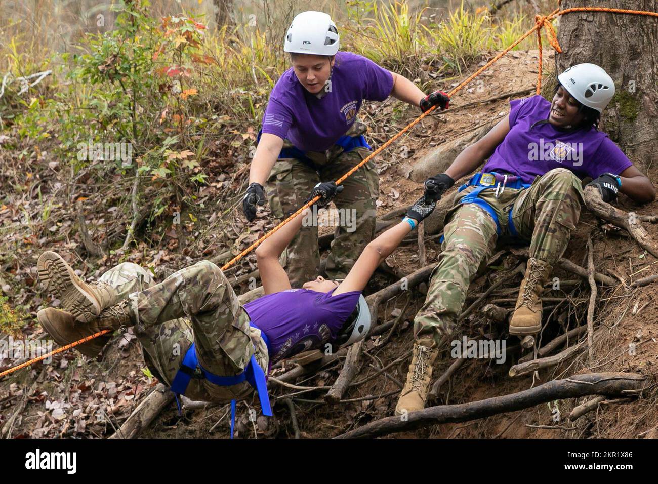 Cypress Lake High School's Army JROTC Raider team work together to get  their teammates across the water in the one-rope bridge event, one of the  five challenges Cadet Raider Teams had to