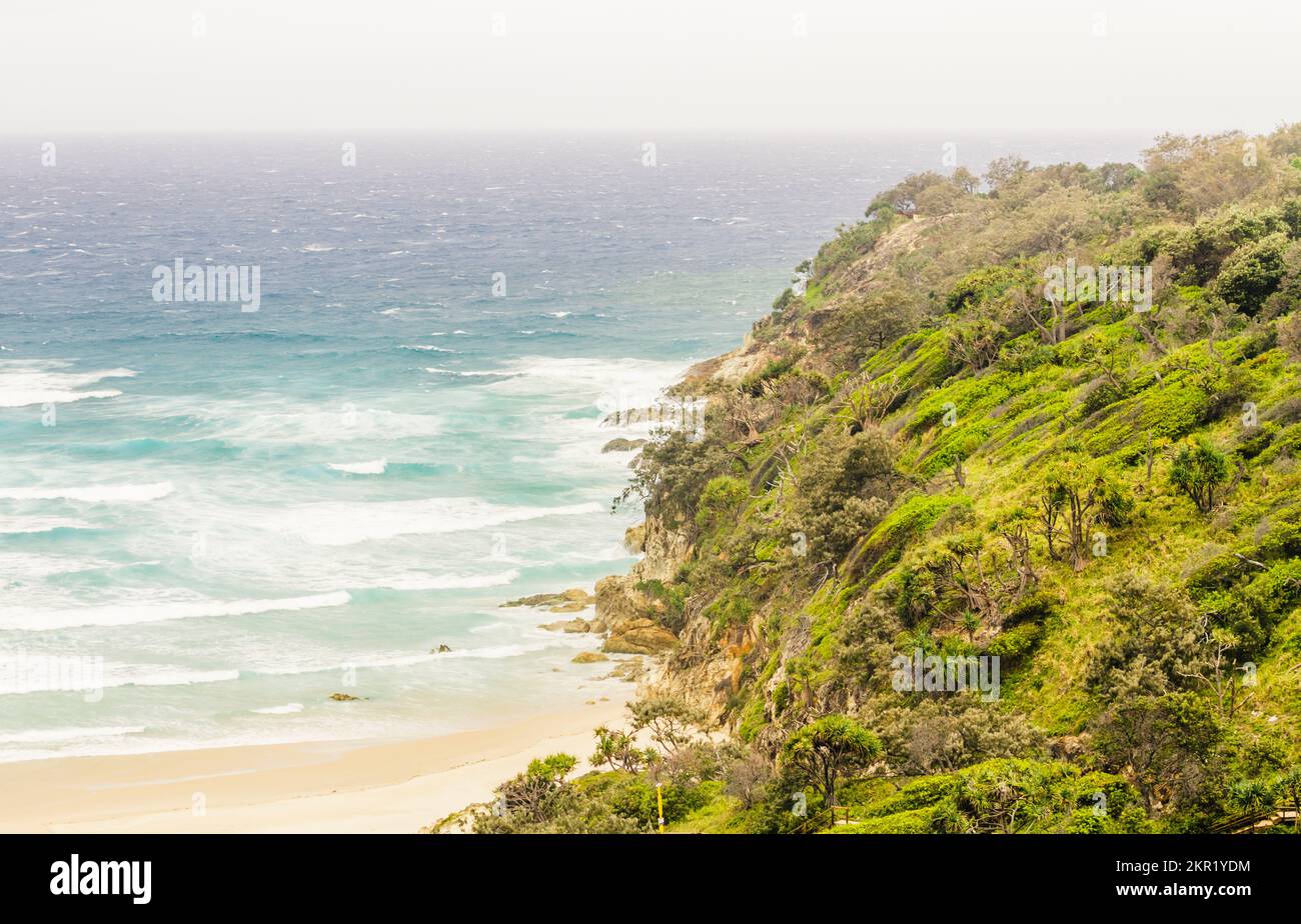 Horizontal oceanscape on a colorful coast of rocky capes and serene blue surf. Taken:  Frenchman's Beach, Point Lookout, North Stradbroke Island, Quee Stock Photo