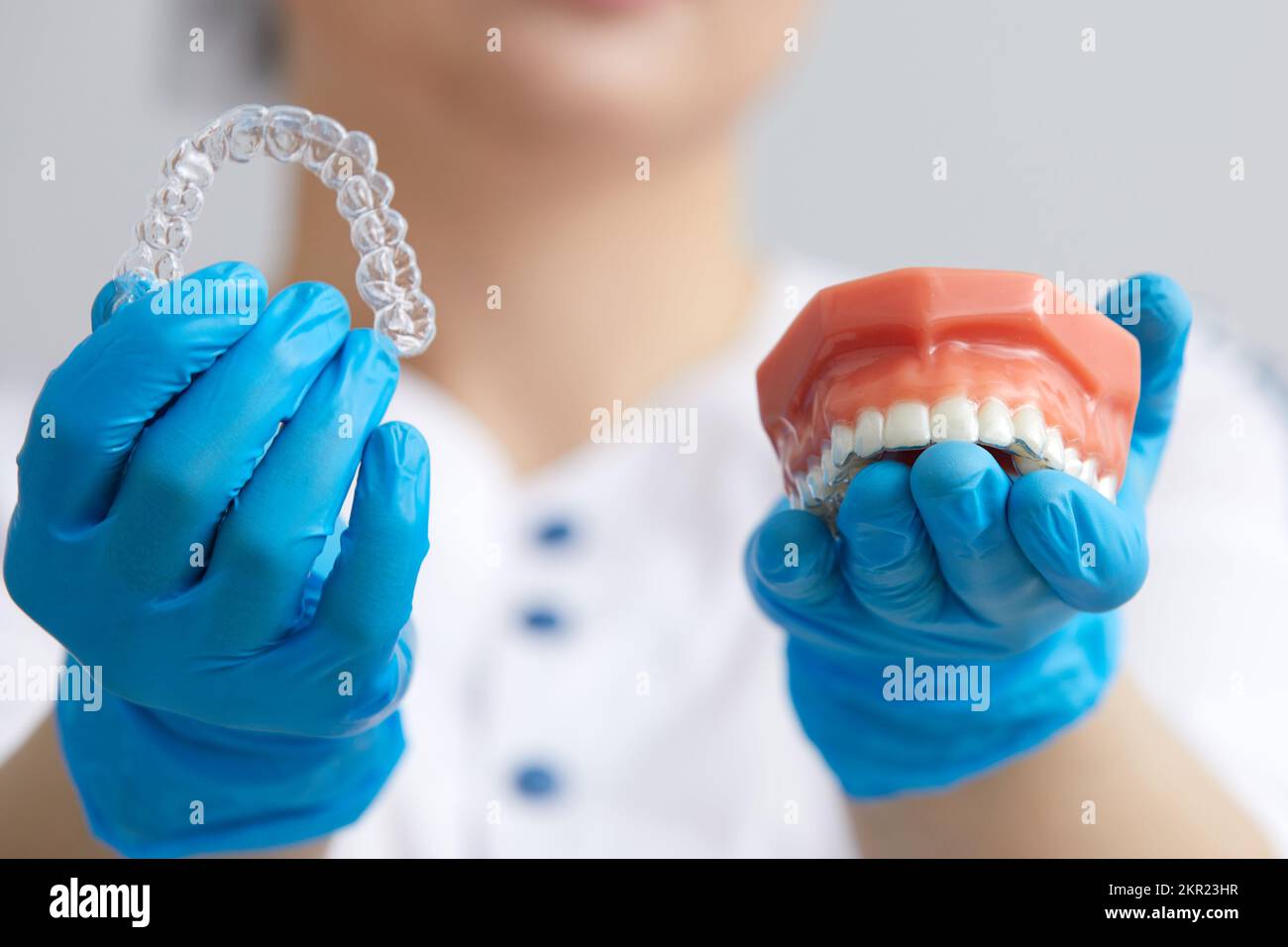 Orthodontist showing the system of aligners on artificial jaws Stock