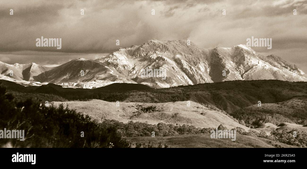 Vintage fine art photo on a sepia toned piece of the West Coast Range with foothills meeting rugged mountain tops. Taken with telephoto from Zeehan , Stock Photo
