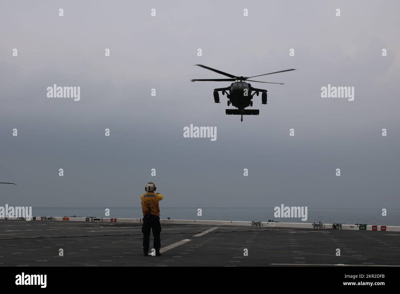 U.S. Navy Aviation Boatswain's mates (handling) coordinate the arrival