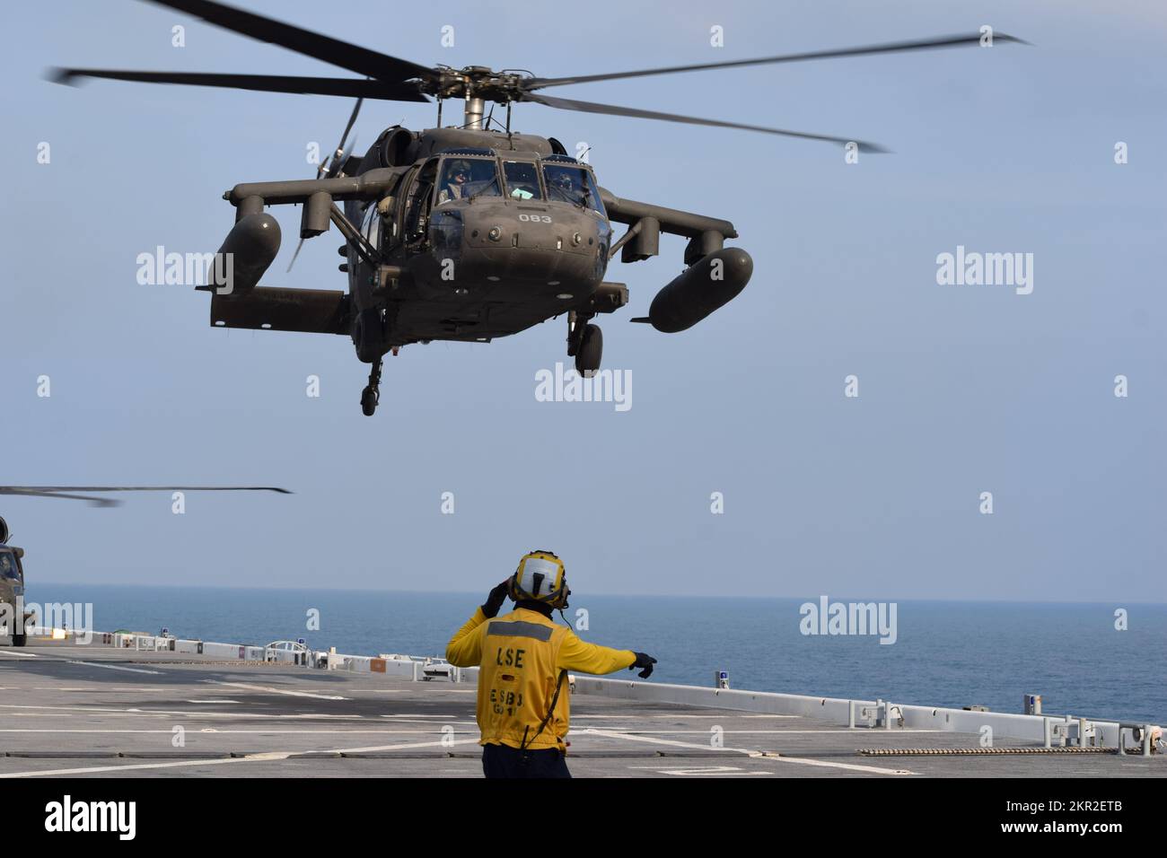 A U.S. Navy aviation boatswain's mate (handling) coordinates the