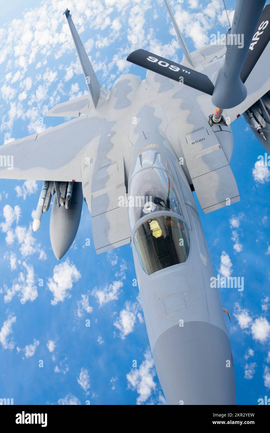 A U.S. Air Force F-15C Eagle assigned to the 18th Wing conducts aerial refueling over the Pacific Ocean, Nov. 22, 2022. With assistance from the KC-135, aircraft are able to stay in the air for longer durations, maximizing the capability to ensure regional security. (U.S. Air Force photo by Airman 1st Class Tylir Meyer) Stock Photo