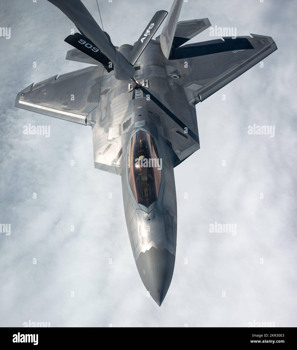 A U.S. Air Force F-22A Raptor assigned to the 3rd Wing, receives fuel from a KC-135 Stratotanker assigned to the 909th Air Refueling Squadron, over the Pacific Ocean, Nov. 23, 2022. The United States' commitment to the peace, security and stability of the lndo-Pacific remains unchanged. (U.S. Air Force photo by Senior Airman Yosselin Campos) Stock Photo