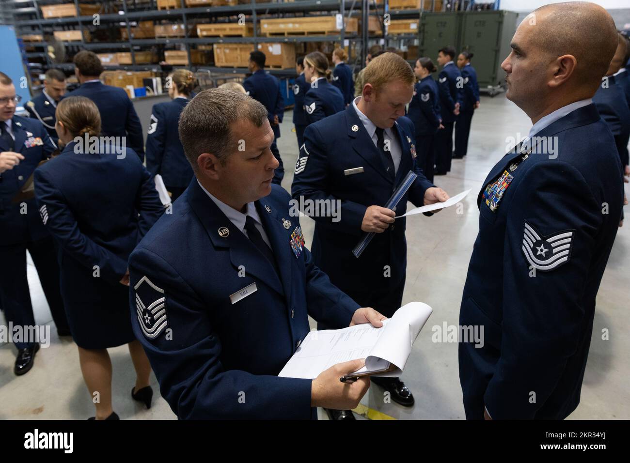 U.S. Air Force Master Sgt. Brett Hall and Master Sgt. Justin Walther  inspect Tech. Sgt. Wyatt Baldwin's dress blues uniform, Nov. 6, 2022, at  the 167th Airlift Wing, Martinsburg, West Virginia. 167th
