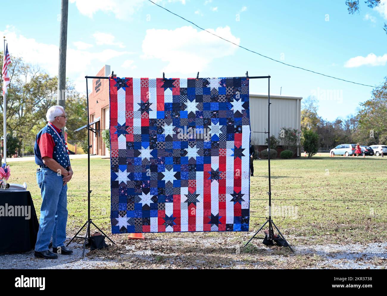 A veteran admires the “Veterans Quilt” at the 11th annual Veterans Appreciation Ceremony in Pike Road, Alabama, Nov. 6, 2022. Provided by the Pike Road Quilters and the Pike Road Arts Council, the honorary quilt is raffled off to a veteran in attendance. Stock Photo