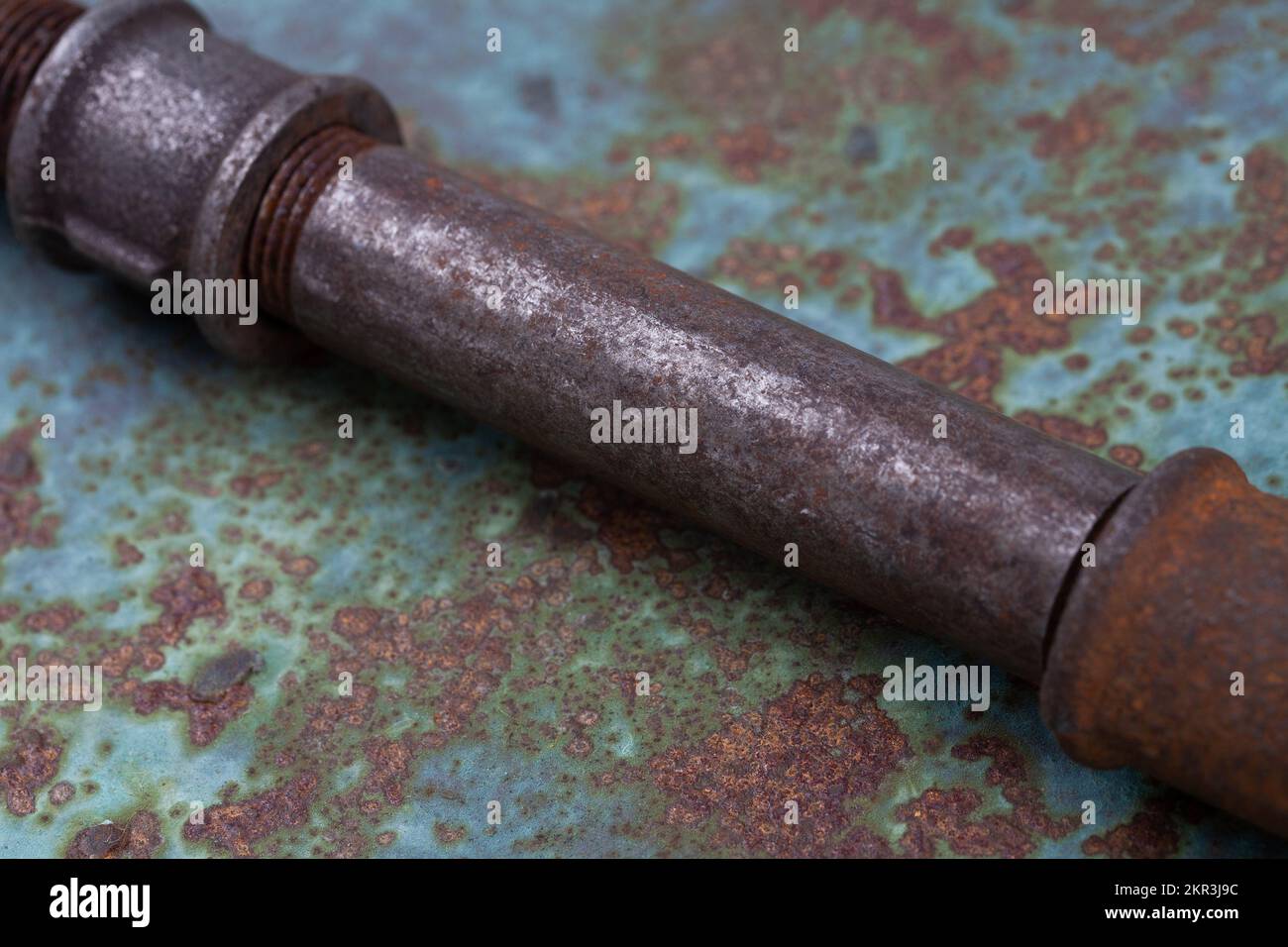 Old rusty valve pipes on rusty metal wall background Stock Photo - Alamy