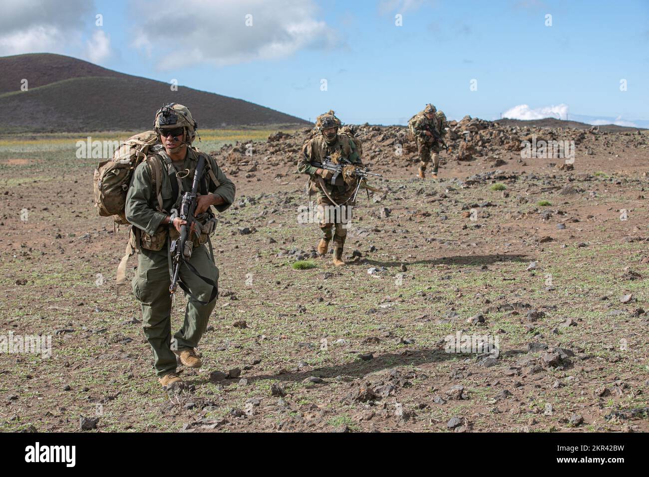 U.S. Army Soldiers from 2nd Battalion, 35th Infantry Regiment, 3rd Infantry Brigade Combat Team, 25th Infantry Division move as a unit while serving as the opposing forces on Pohakuloa Training Grounds, Nov. 7, 2022. Bilateral and multilateral exercises strengthen relationships and enhance interoperability with allies and partners through shared experiences and tough, realistic training. We routinely invite and encourage allies and partners to participate in JPMRC rotations. Stock Photo