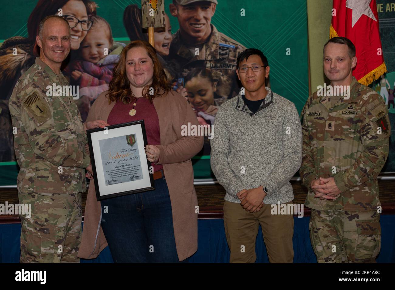 Taylor Winborn (middle left) receives a Volunteer of the Quarter Award ...