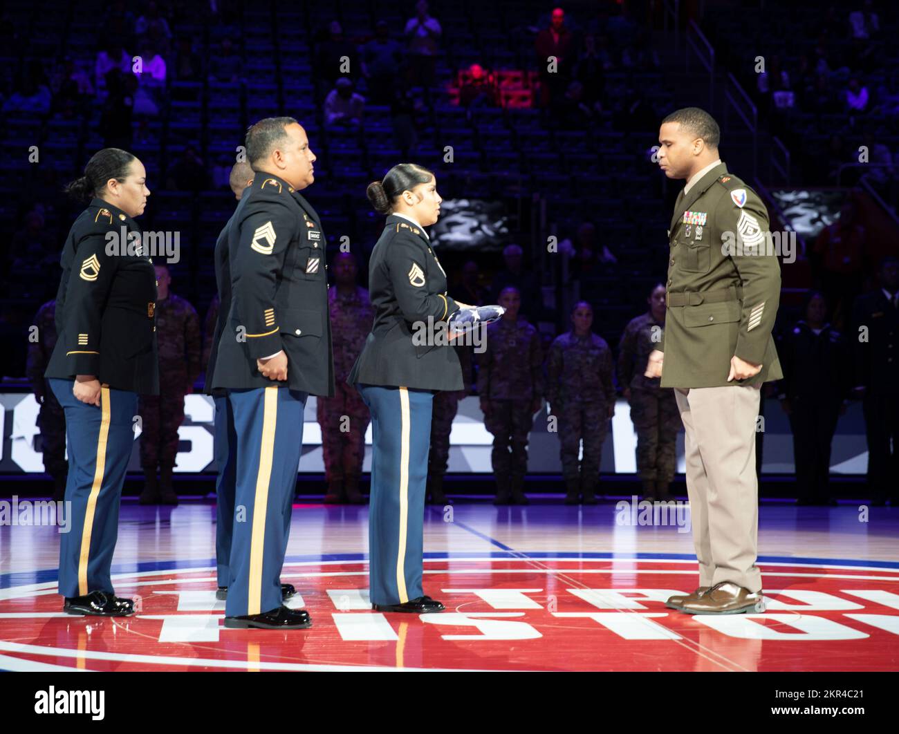 DETROIT, Mich. - 1st Sgt Christopher Jackson awaits to receive the hand off of the flag after the 13 fold Old Glory ceremony was completed  during the Detroit Pistons military appreciation event at Little Caesars Arena on November 7, 2022. (Army Reserve photo by Spc. Isaac Copeland, 220th Public Affairs Detachment).    The Detroit Pistons honor the service of our veterans at the Military Appreciation (Hoops for Troops) game in honor of Veterans Day. Veterans Day is a way to say thank you to all those who have served with the highest appreciation. Those who have risked their lives making sacrif Stock Photo