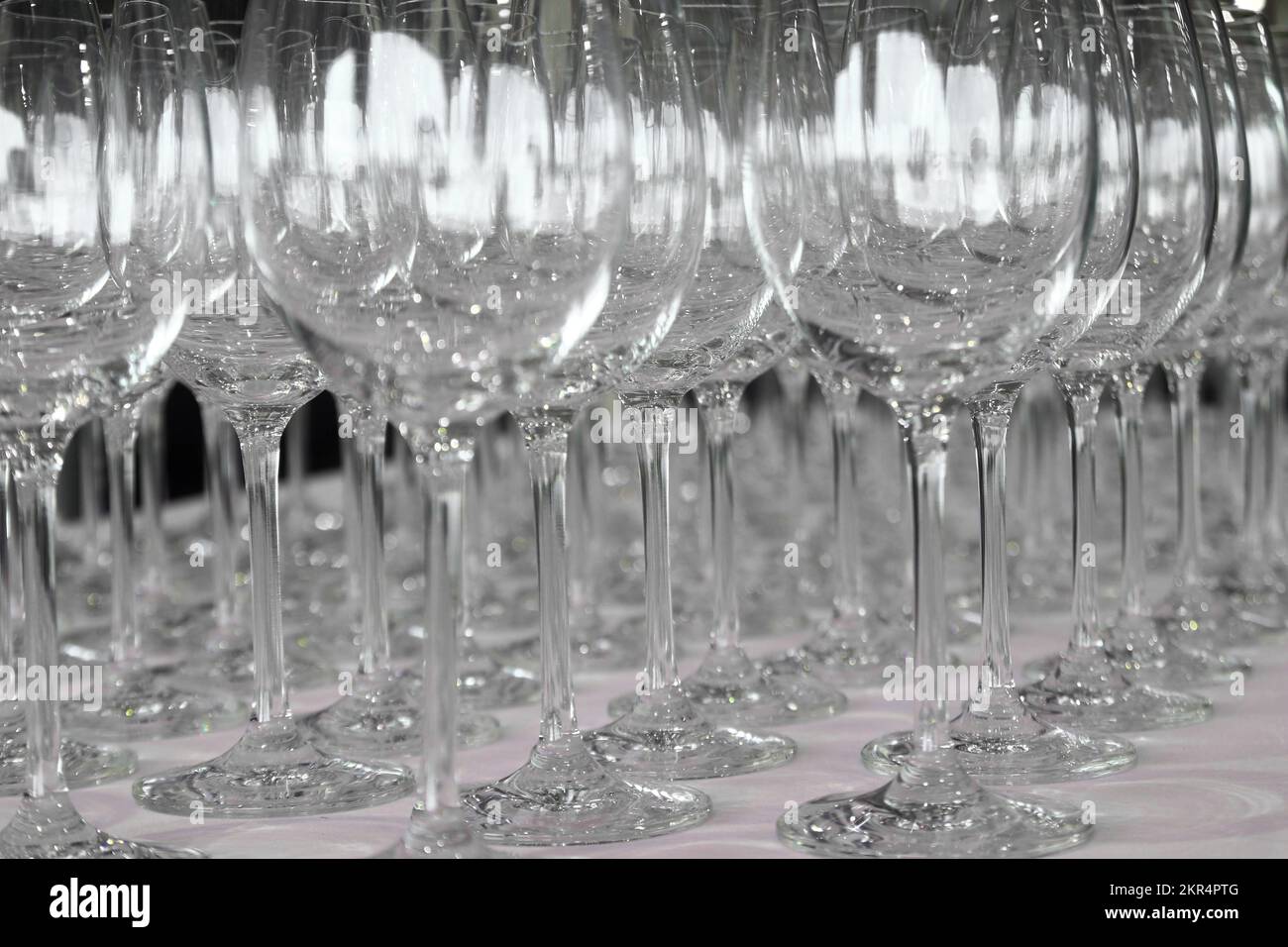pile of empty wine glasses on table Stock Photo