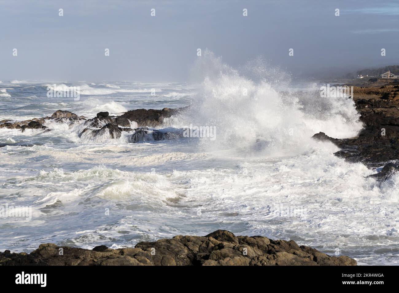 Huge waves crashing against the rocky shoreline during a king tide in Yachats, Oregon. Stock Photo