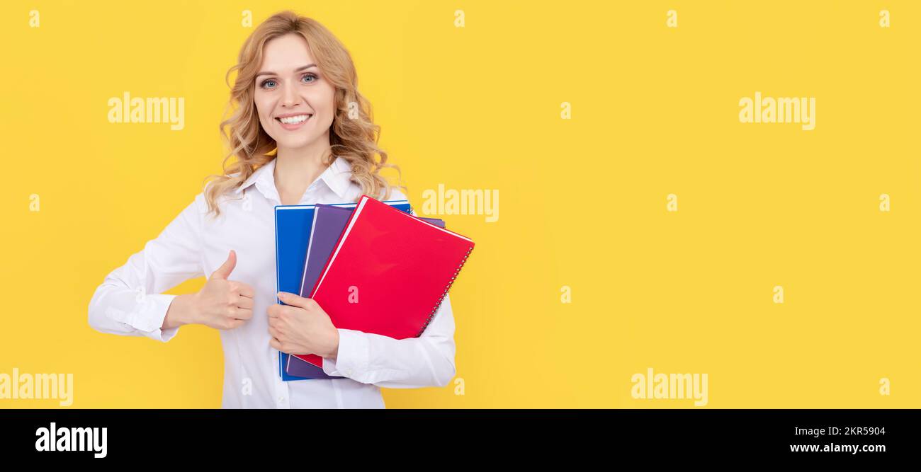 Business woman with book. happy blonde businesswoman woman in white shirt hold notepad or notebook, thumb up. Woman isolated face portrait, banner Stock Photo