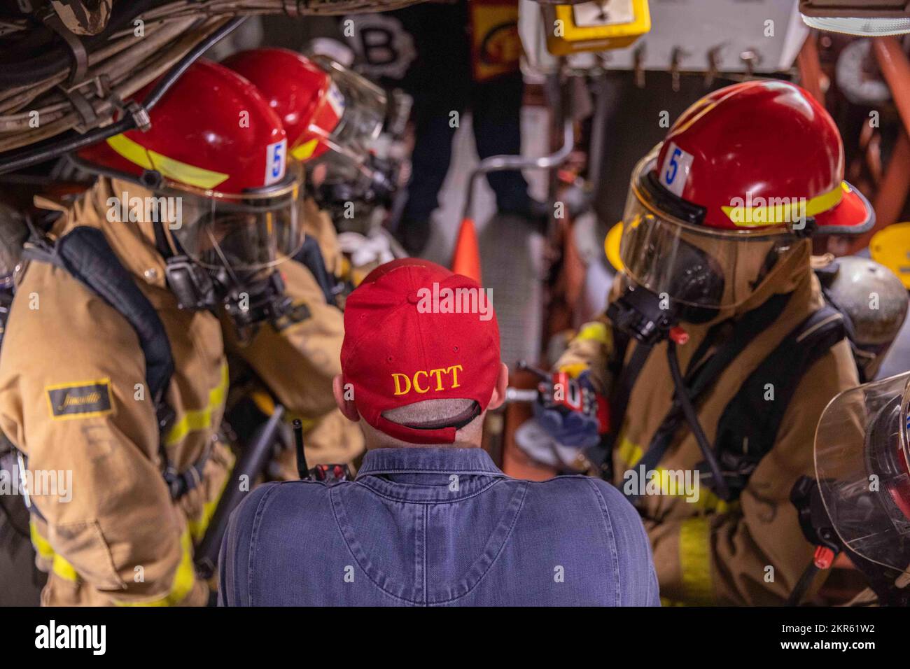 Damage Controlman 1st Class Charles Gunther, center, monitors Sailors ...