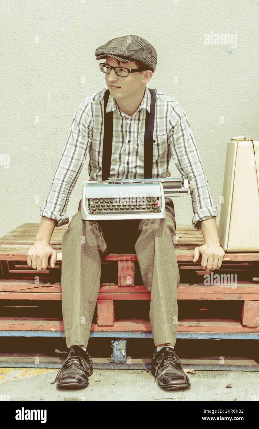 Green toned vintage image of a handsome creative writer in 20s with