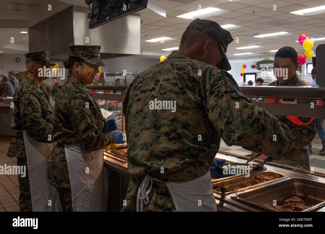 The 3rd Marine Aircraft Wing leadership serves food to Marines and ...
