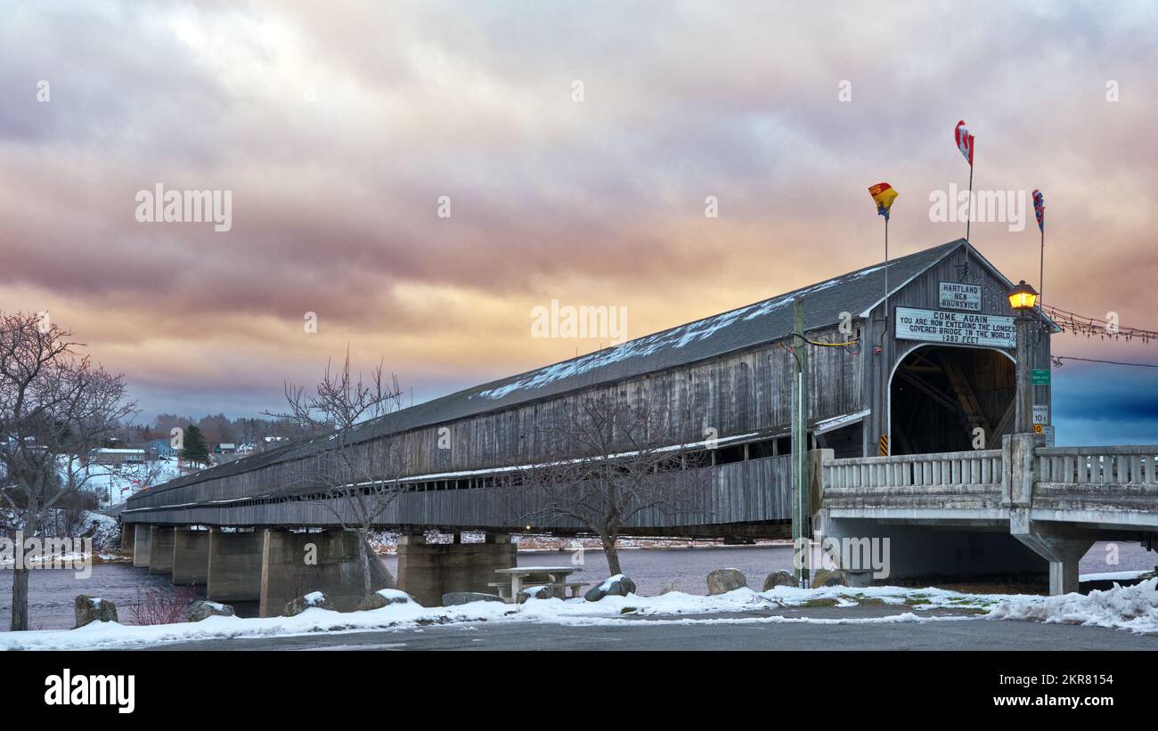A covered bridge spans the St. John River near Hartland New Brunswick.  Billed as the worlds longest covered bridge it has a length of 1282 feet. Stock Photo