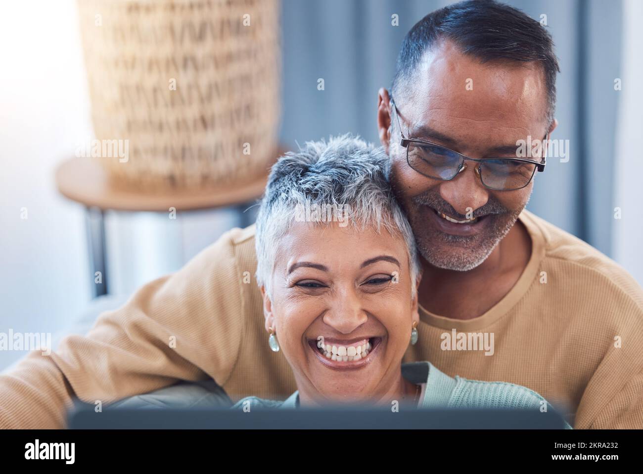 Senior couple, happy and laptop while online streaming movie, show or comic video and laughing at meme using home wifi on social media. Face of man Stock Photo