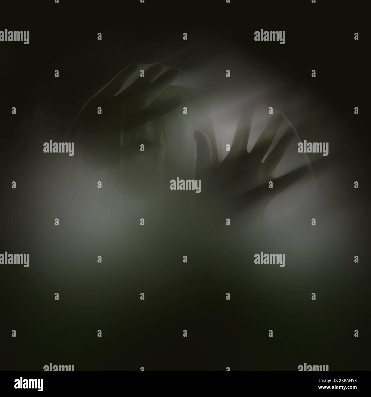 Fingers of icy fear. A ghostly apparition of a woman isolated on a black background. Stock Photo