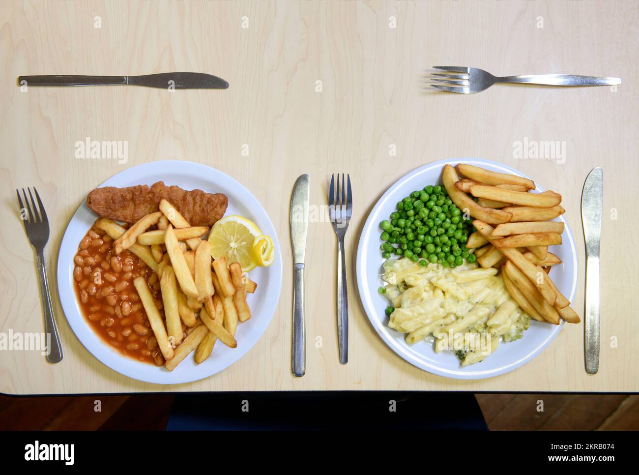 School dinners - fish & chips with peas and cheese & broccoli pasta with chips. Stock Photo