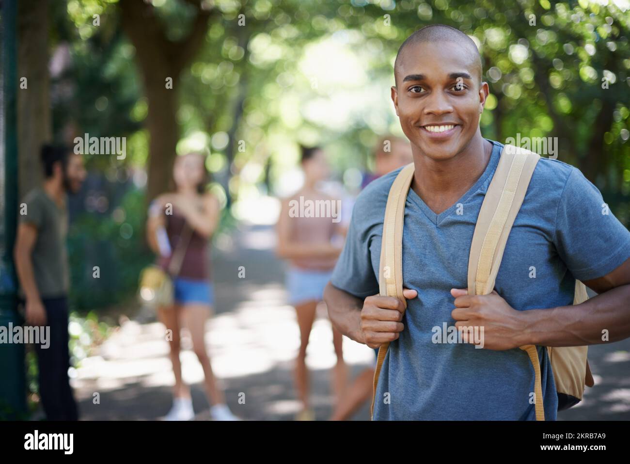 Dedicated to his studies. Portrait of a handsome young man on campus ...