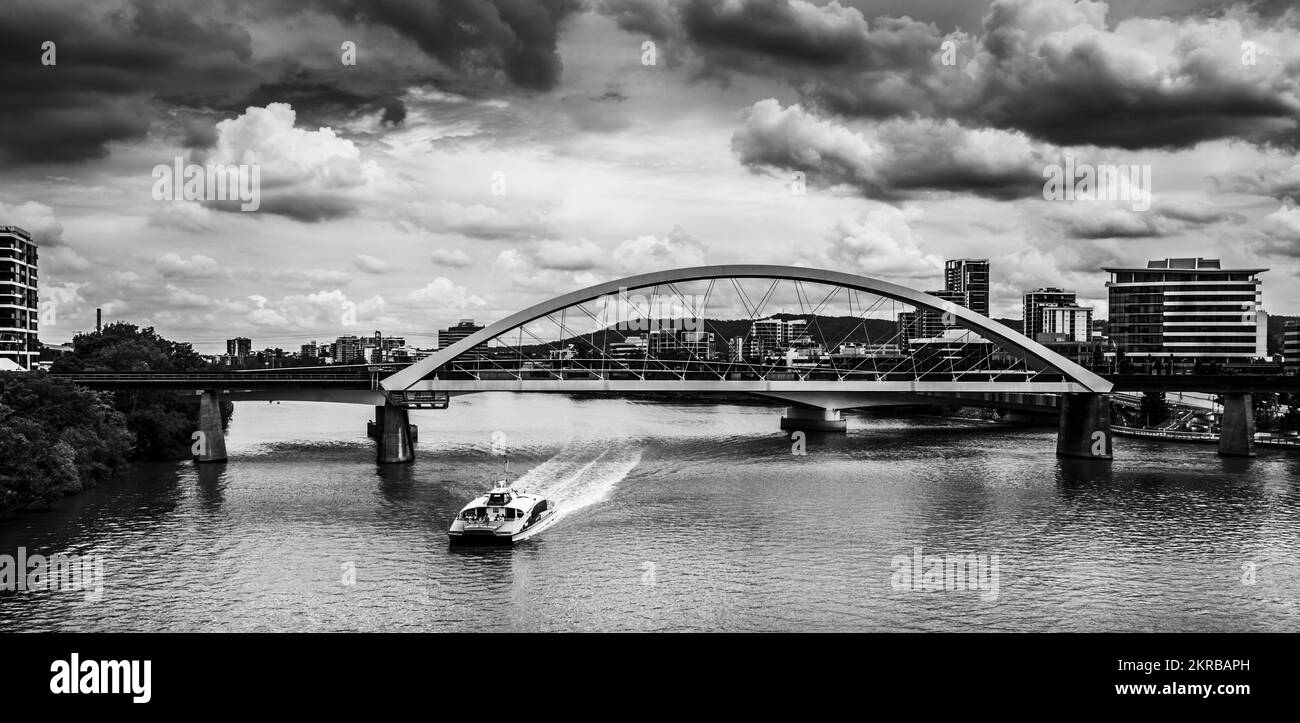 Black and white river landscape on a citycat ferry before bridges and urban architecture. Merivale Bridge, Brisbane City, Queensland, Australia Stock Photo
