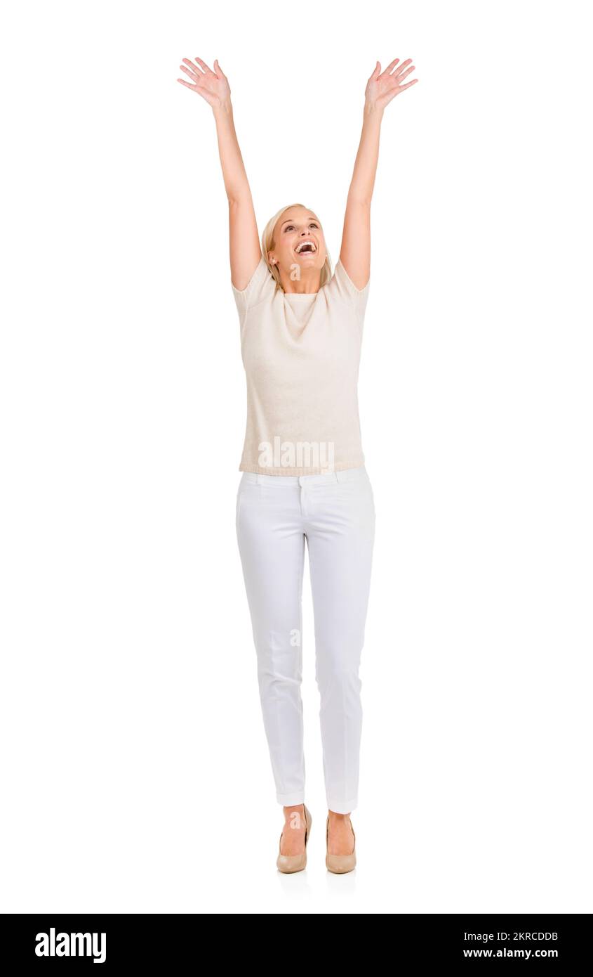 I did it. A happy young blonde looking up with her hands in the air. Stock Photo