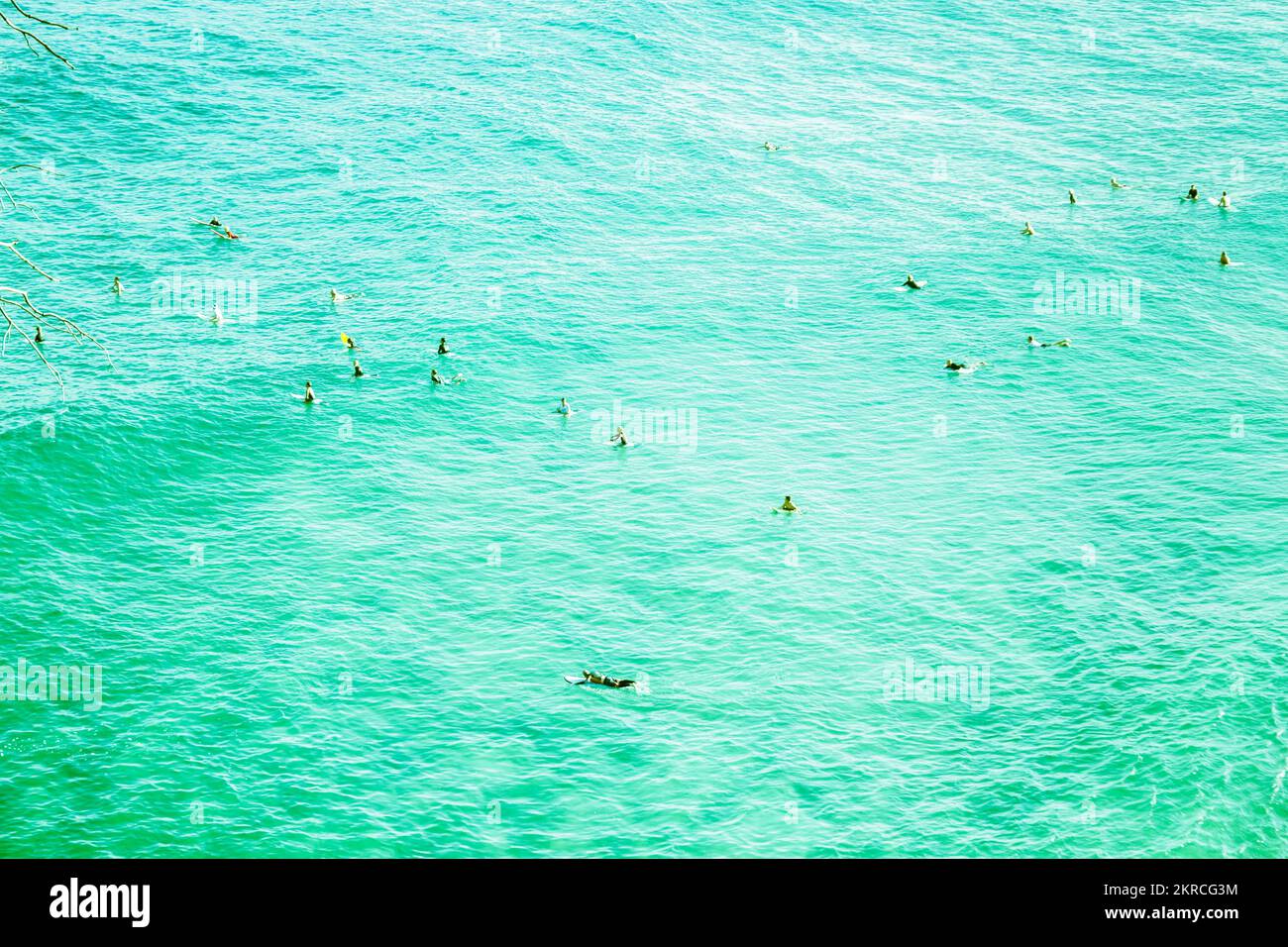 Aquatic blue lifestyle photo on a wave of surfers at tropical island location. Taken: Main Beach, Point Lookout, North Stradbroke Island, Queensland, Stock Photo