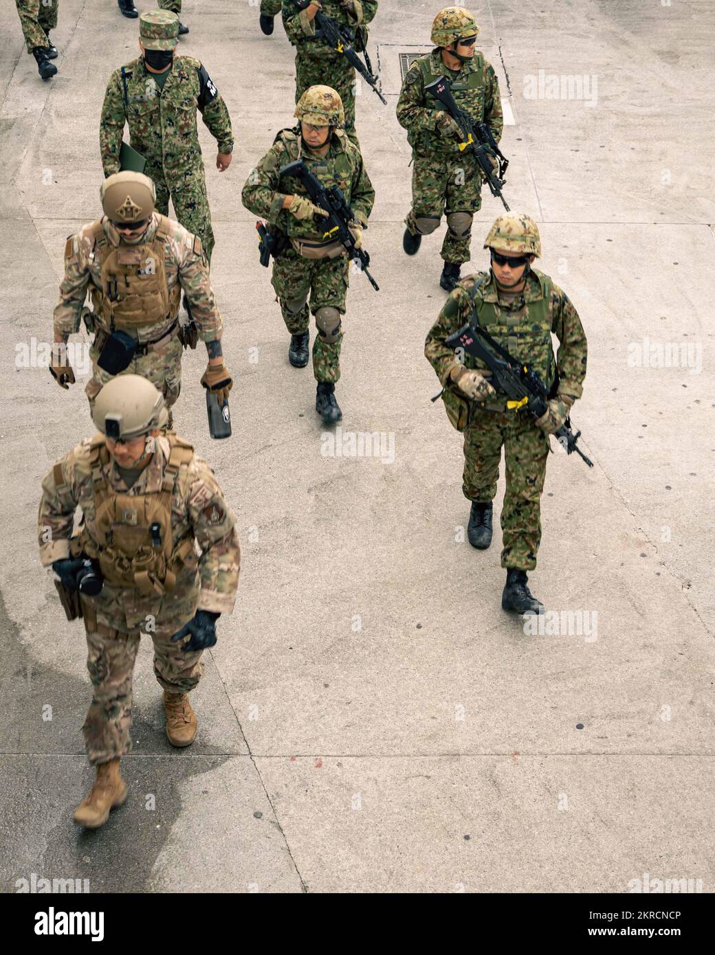 U.S. airmen with the 18th Security Forces Squadron, and members with the Japan Ground Self-Defense Force, 51st Infantry Regiment, patrol a sidewalk during a simulated bilateral search while participating in Exercise Keen Sword 2023 on Camp Foster, Okinawa, Japan, Nov. 13, 2022. Keen Sword exercises the combined command and control capabilities and lethality developed between MCIPAC, III Marine Expeditionary Force, and the Japan Self-Defense Force. This bilateral field-training demonstrates the U.S. military and JSDF interoperability and combat readiness of the U.S.-Japan Alliance. Stock Photo