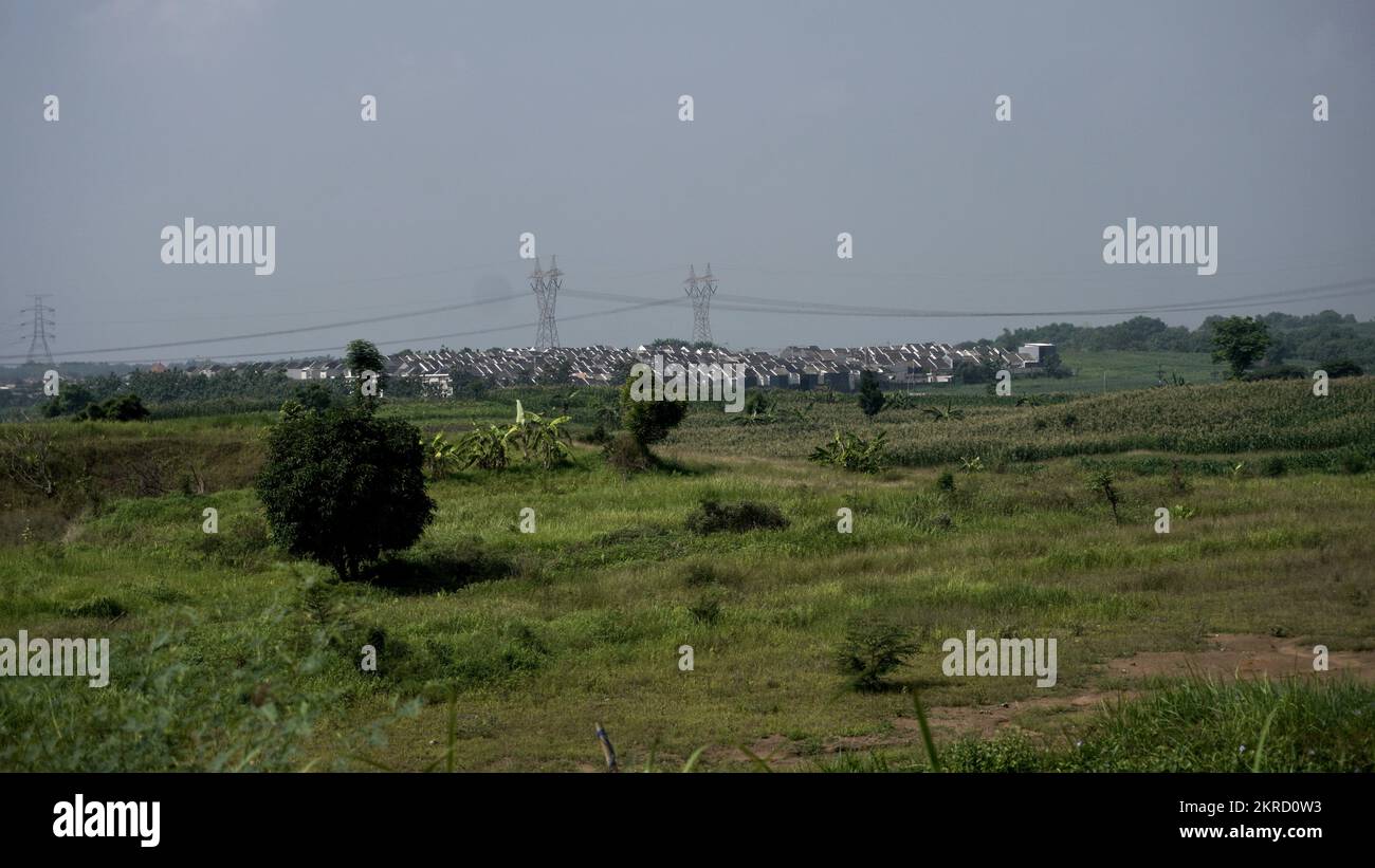 Unfinish housing area at village with hill and electricity tower background Stock Photo