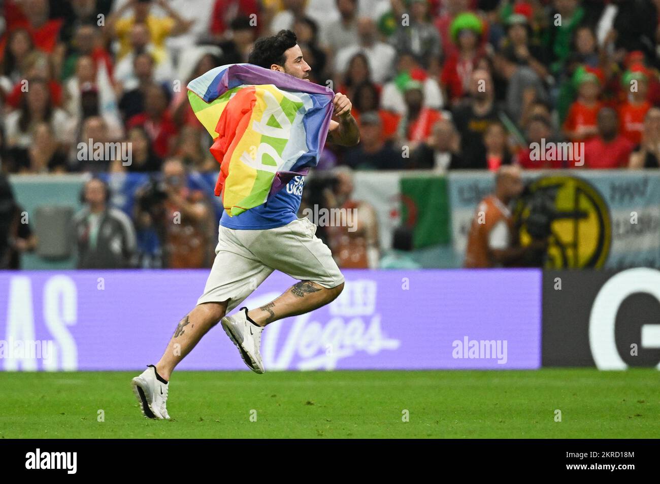 Doha, Qatar. 28th Nov, 2022. A man carrying a rainbow flag and wearing a T-shirt in support of Iranian women ran into the pitch during Portugal v Uruguay match of the Fifa World Cup Qatar 2022 Al Lusail Stadium in Doha, Qatar on November 28, 2022. Photo by Laurent Zabulon/ABACAPRESS.COM Credit: Abaca Press/Alamy Live News Stock Photo