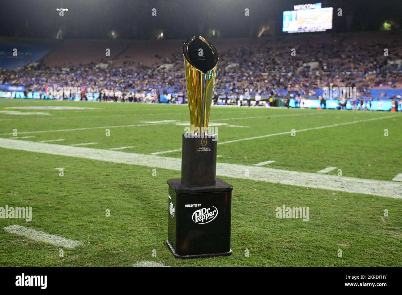 The College Football Playoff National Championship trophy sits on the sideline during an NCAA football game between the UCLA Bruins and the Washington Stock Photo