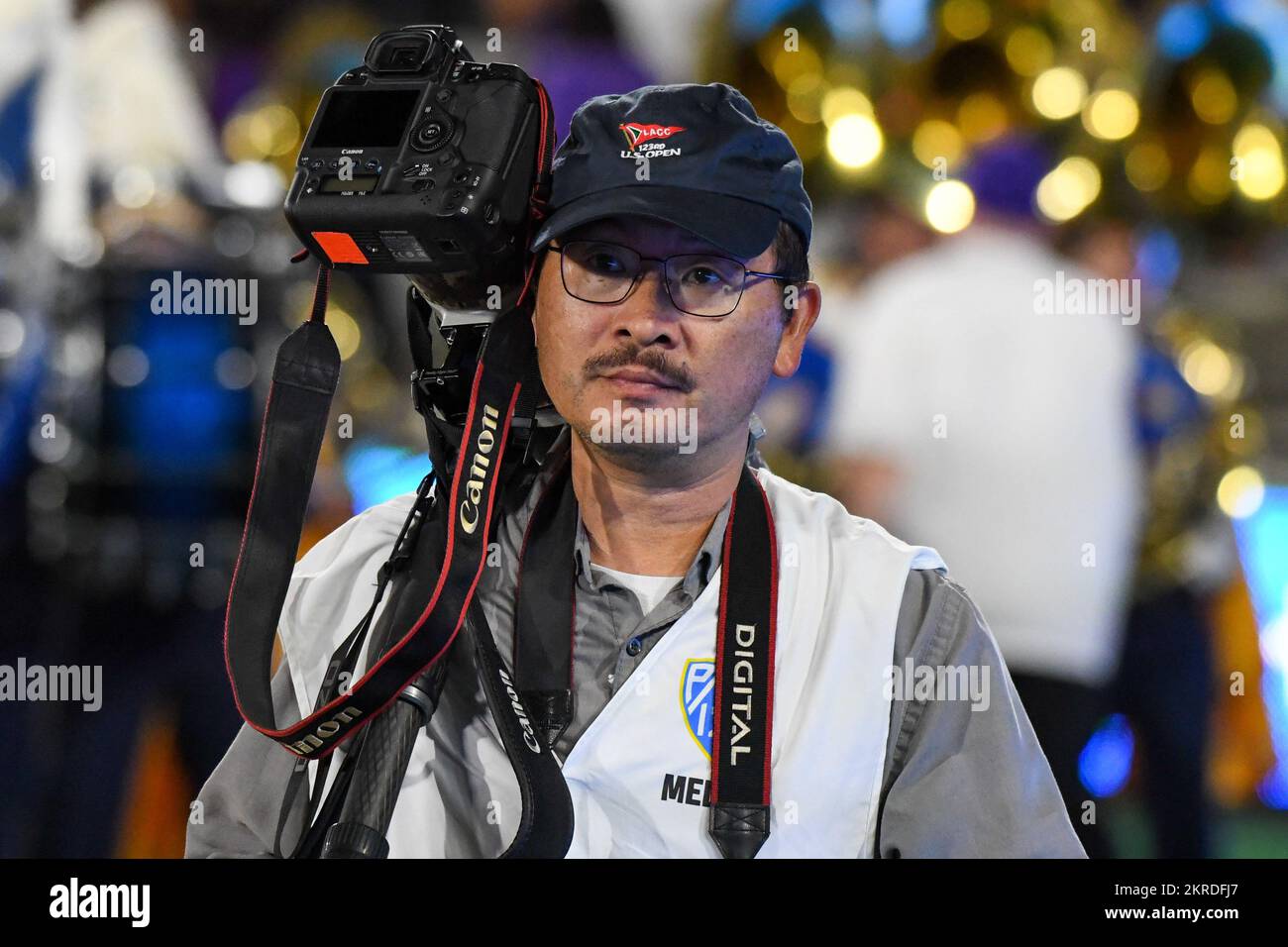 Photographer Ringo Chiu walks on the sidelines during an NCAA football game, Friday, Sep. 30, 2022, in Pasadena, Calif. The UCLA Bruins defeated Washi Stock Photo