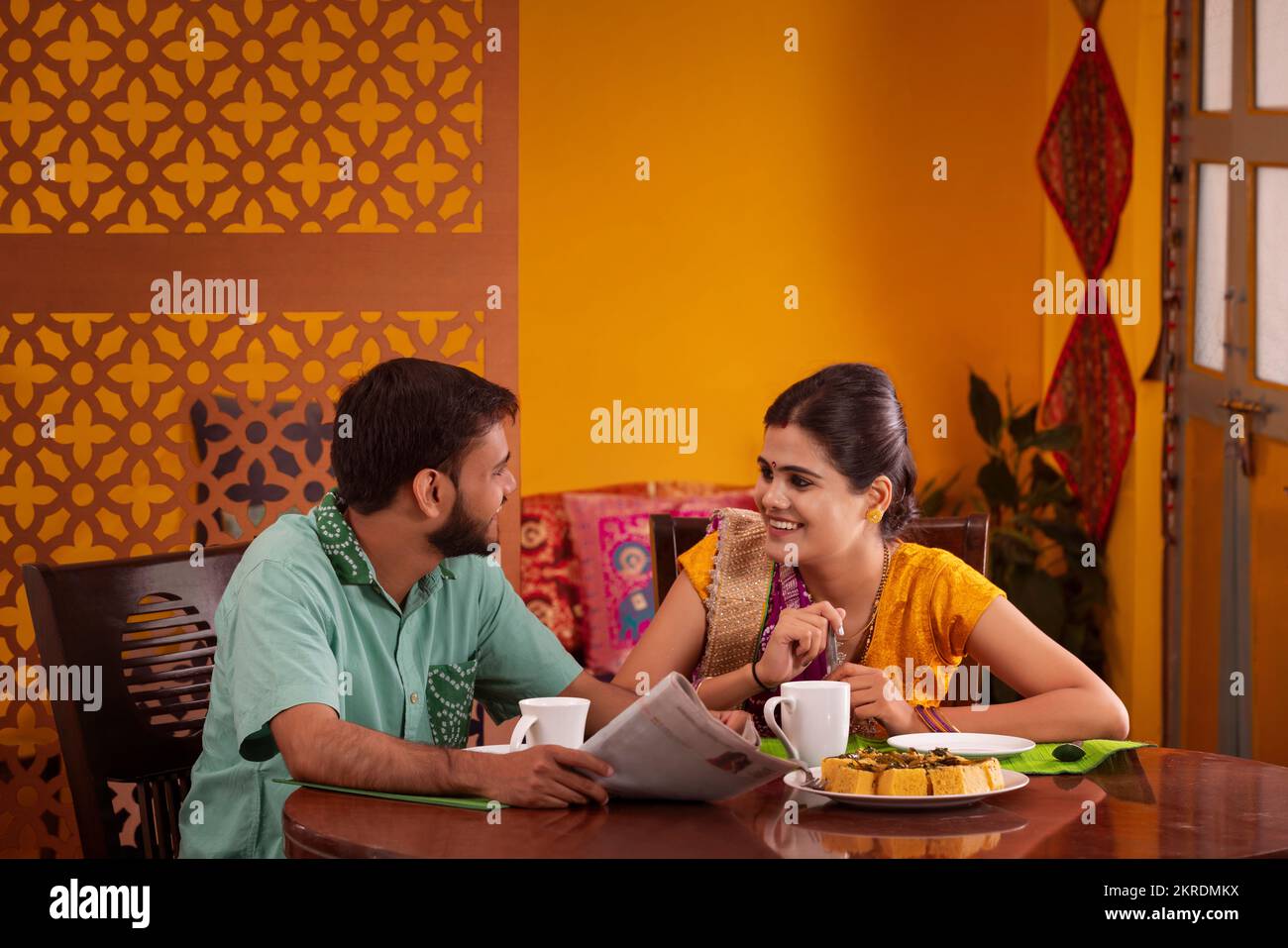 Gujrati couple talking during breakfast Stock Photo
