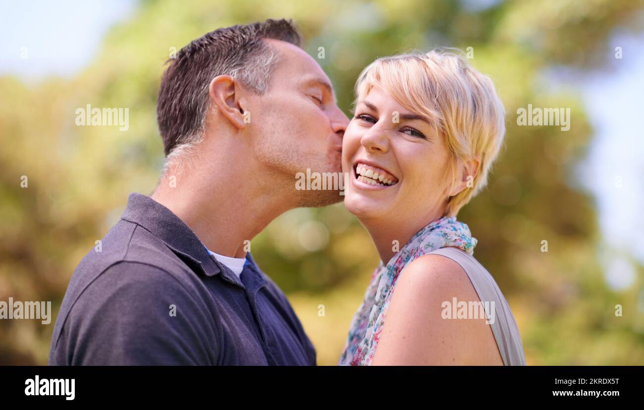 Wife kissing husband on cheek hi-res stock photography and images - Alamy