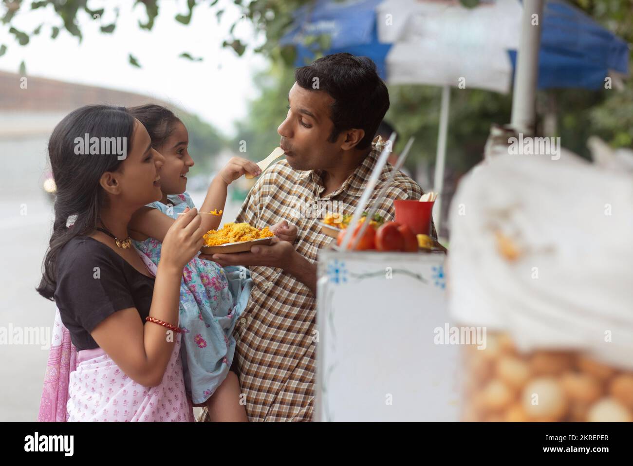 Portrait of happy family eating bhelpuri Stock Photo