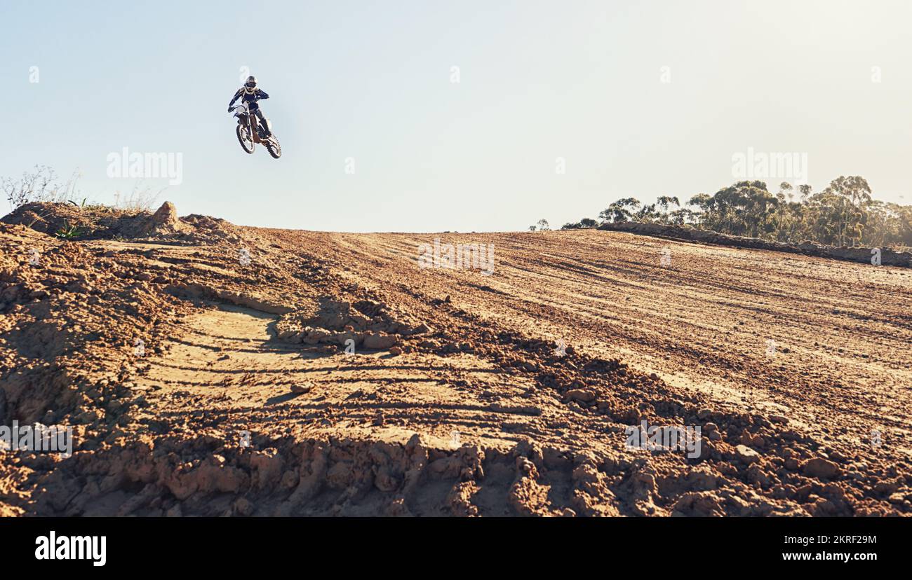 Hitting the ramp at high speed. a motocross rider coming over a jump