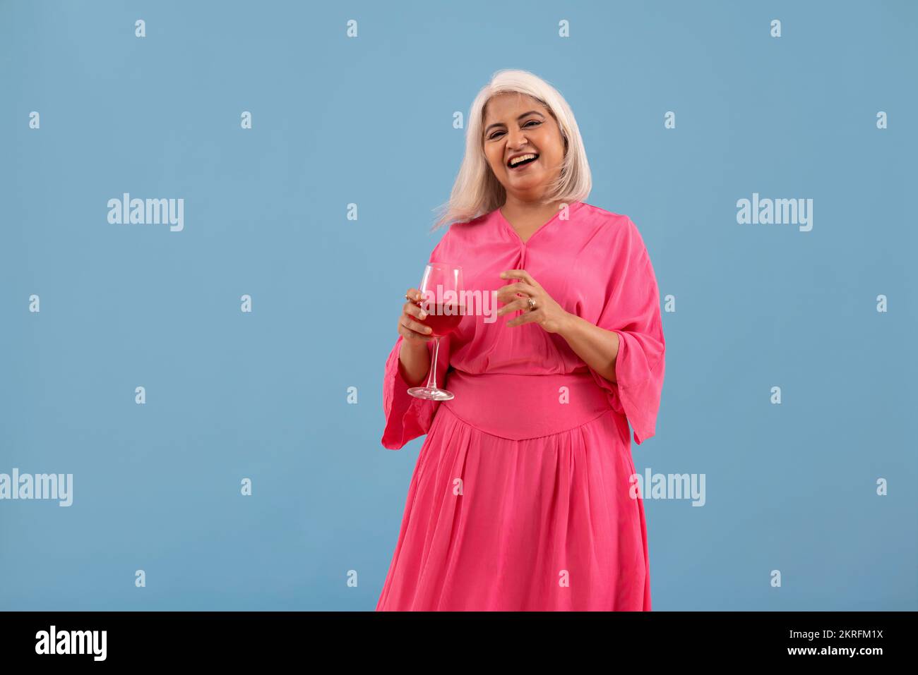 Portrait of a cheerful old lady standing with a glass of red wine Stock ...