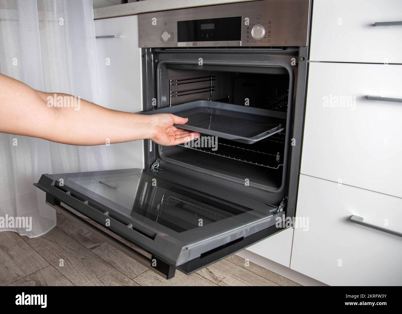 Modern electric oven with telescopic rails and steel baking tray